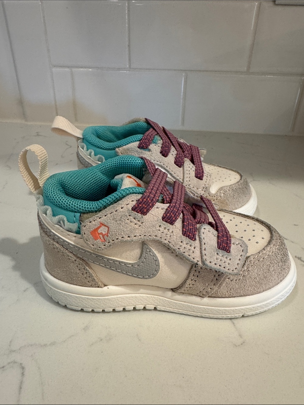 Baby Girl’s Nike Jordan Beige and Teal Athletic Sneakers with Purple Laces